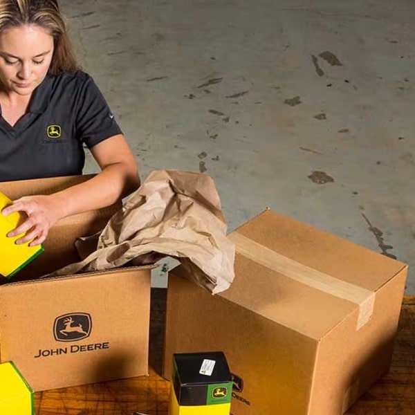 Revels parts team member unpacking John Deere parts